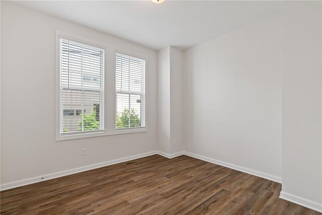 1227 Cushenberry Ln, Atlanta, GA 30318 - bathroom with toilet, wood finished floors, baseboards, vanity, and shower / bath combination