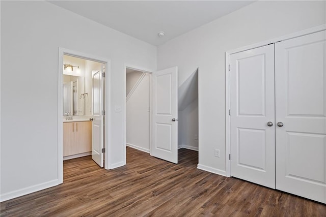 1227 Cushenberry Ln, Atlanta, GA 30318 - unfurnished bedroom featuring dark wood-type flooring, a closet, baseboards, ensuite bath, and a sink