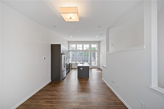 1227 Cushenberry Ln, Atlanta, GA 30318 - corridor featuring dark wood-style flooring, baseboards, recessed lighting, and a sink