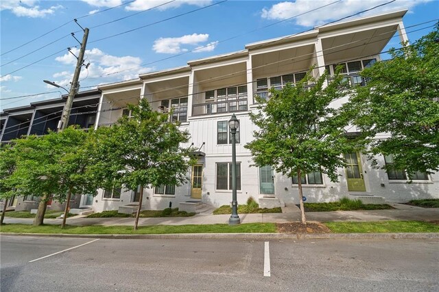 1227 Cushenberry Ln, Atlanta, GA 30318 - empty room with dark wood finished floors, healthy amount of natural light, and baseboards