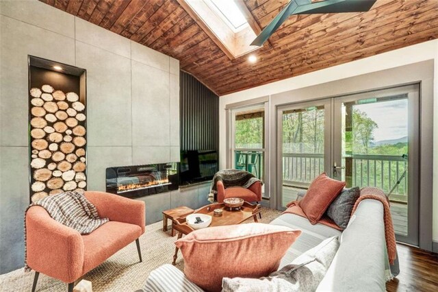 361 Rising Star Rd, Ellijay, GA 30536 - living area featuring a tile fireplace, wooden ceiling, a skylight, high vaulted ceiling, and wood finished floors