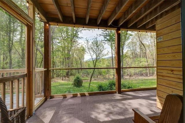 361 Rising Star Rd, Ellijay, GA 30536 - unfurnished sunroom featuring carpet flooring, plenty of natural light, and a wooded view