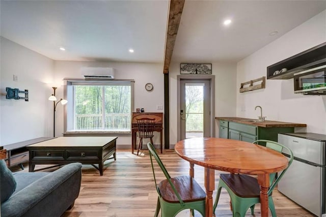 361 Rising Star Rd, Ellijay, GA 30536 - dining area featuring light wood finished floors, a wall mounted air conditioner, recessed lighting, and beamed ceiling