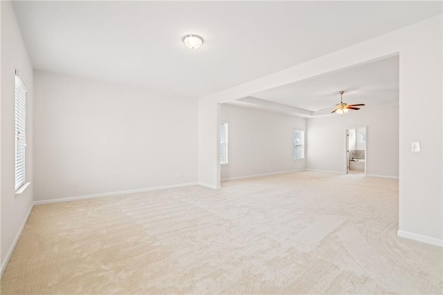 spare room featuring light carpet and ceiling fan