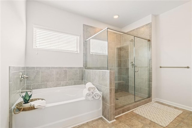 bathroom with tile patterned floors and independent shower and bath