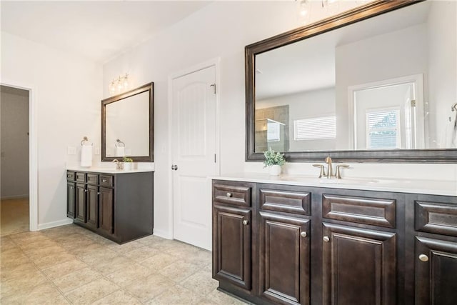 bathroom with walk in shower and vanity