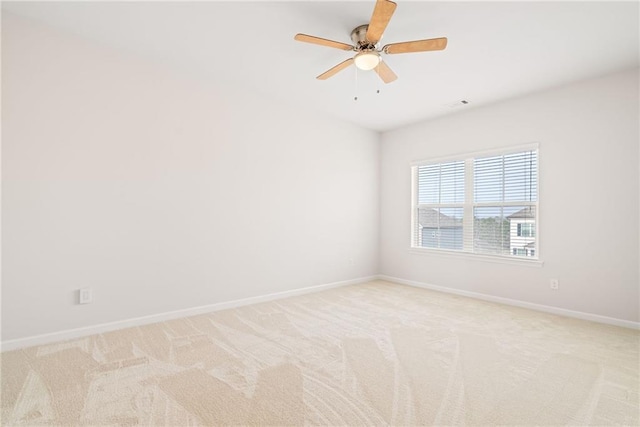 spare room with light colored carpet and ceiling fan