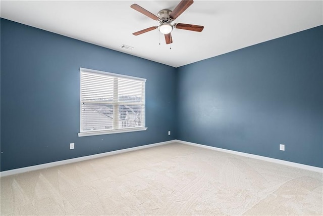 spare room featuring carpet and ceiling fan