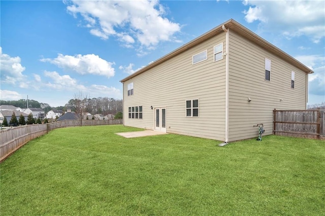 rear view of house with a patio and a lawn