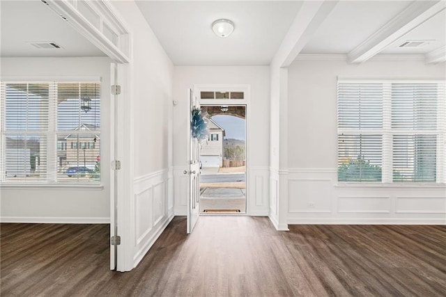 foyer with a healthy amount of sunlight, dark hardwood / wood-style floors, and beam ceiling