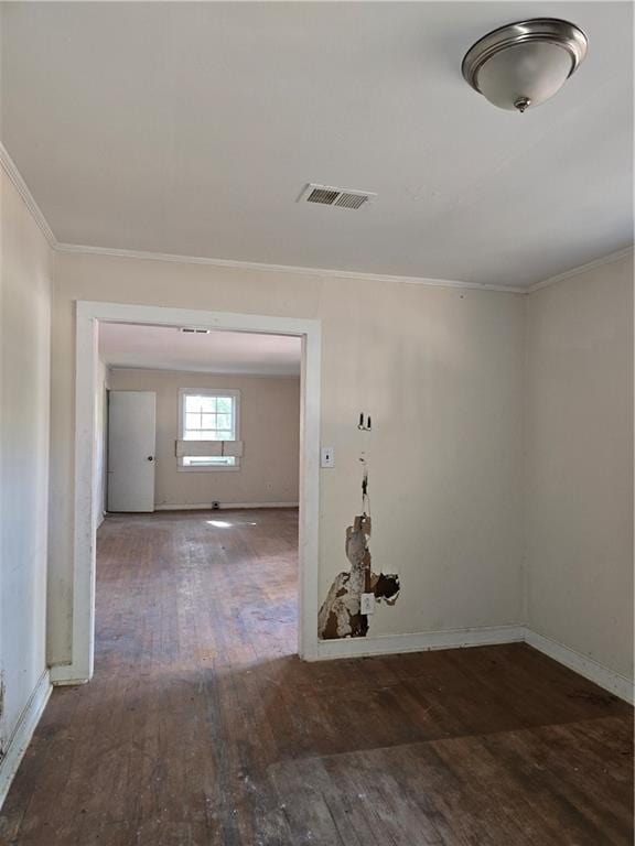 hallway with hardwood / wood-style floors, ornamental molding, and baseboards