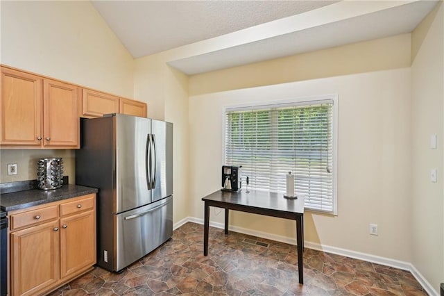 3705 Tate Pl, Austell, GA 30106 - kitchen with freestanding refrigerator, dark stone finish floors, dark countertops, lofted ceiling, and baseboards