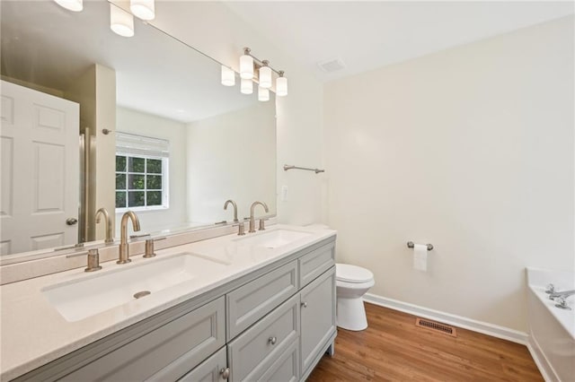 3705 Tate Pl, Austell, GA 30106 - full bath featuring a bath, double vanity, baseboards, toilet, and wood finished floors
