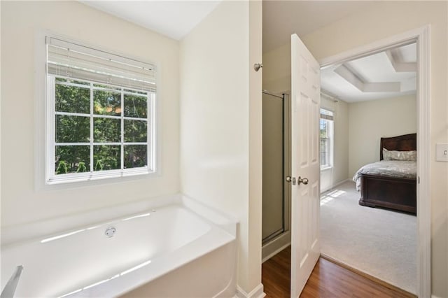 3705 Tate Pl, Austell, GA 30106 - ensuite bathroom with a garden tub, a shower stall, baseboards, and wood finished floors