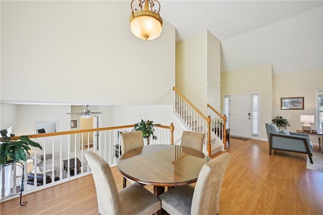3705 Tate Pl, Austell, GA 30106 - dining area featuring wood finished floors, high vaulted ceiling, a ceiling fan, and stairway