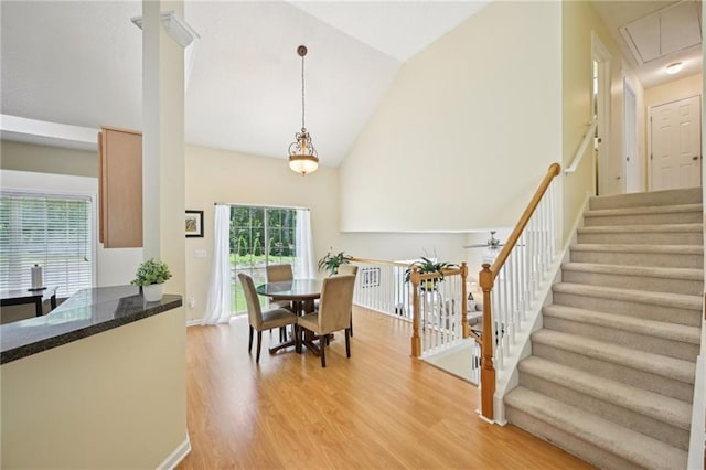 3705 Tate Pl, Austell, GA 30106 - dining room with high vaulted ceiling, light wood-style floors, attic access, and stairway