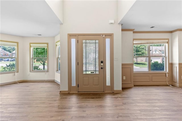 1492 Station Ridge Ct, Lawrenceville, GA 30045 - foyer entrance with wood finished floors, plenty of natural light, and a wainscoted wall