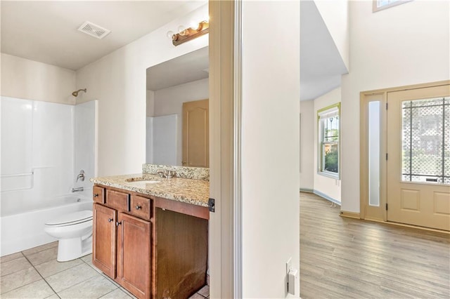 1492 Station Ridge Ct, Lawrenceville, GA 30045 - bathroom featuring vanity, washtub / shower combination, plenty of natural light, and wood finished floors