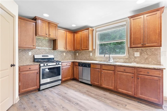 1492 Station Ridge Ct, Lawrenceville, GA 30045 - kitchen featuring stainless steel appliances, light wood-type flooring, light stone countertops, decorative backsplash, and recessed lighting