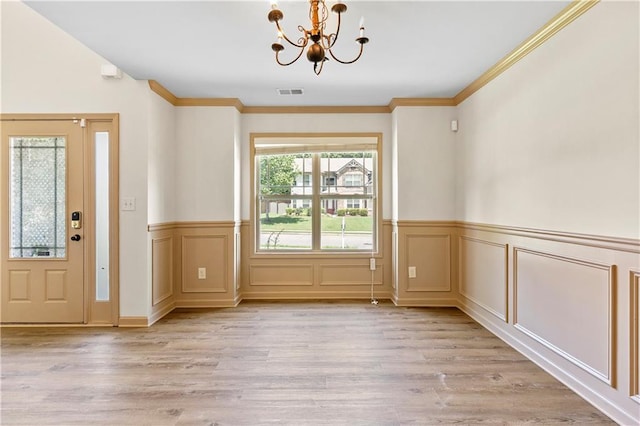 1492 Station Ridge Ct, Lawrenceville, GA 30045 - entryway featuring a chandelier, light wood-style floors, a wainscoted wall, and crown molding