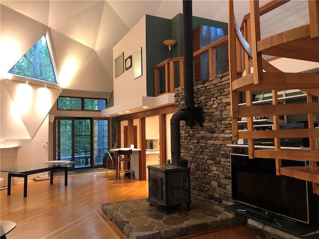 5015 Wright Bridge Rd, Cumming, GA 30028 - living area featuring a wood stove, wood finished floors, and a towering ceiling