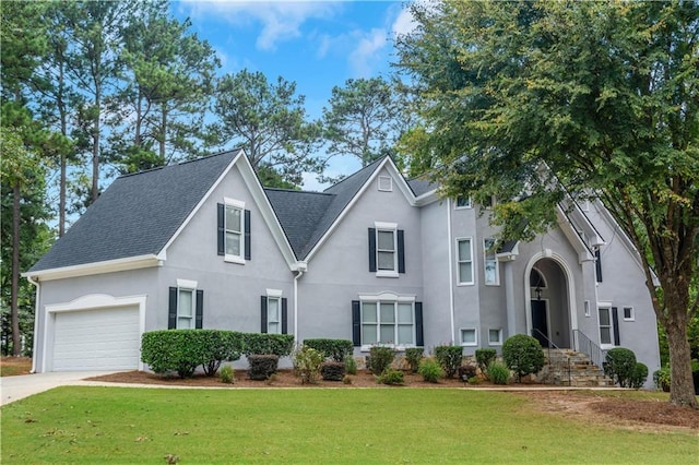 view of front of property featuring a garage and a front yard