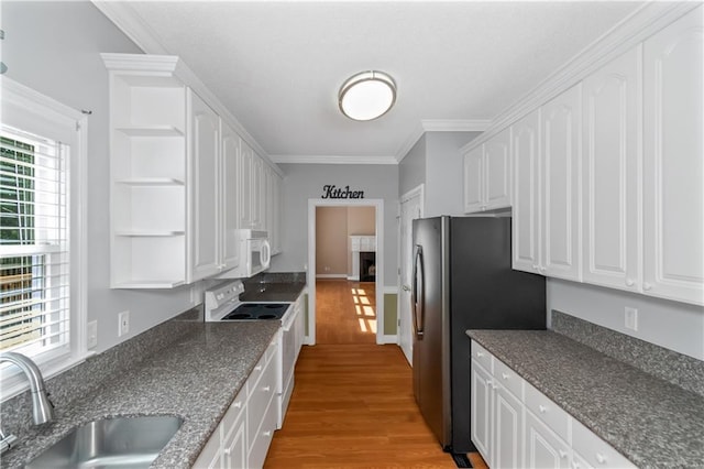 kitchen with white cabinetry, sink, ornamental molding, white appliances, and light hardwood / wood-style flooring