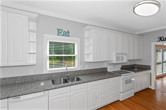 kitchen featuring sink, white cabinets, light hardwood / wood-style floors, a healthy amount of sunlight, and white appliances