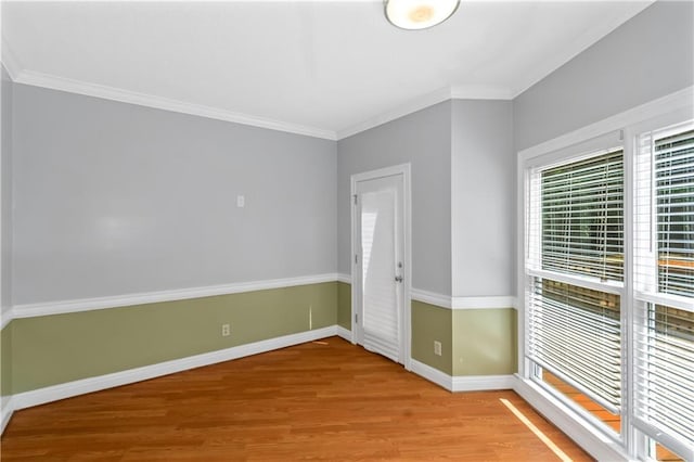 spare room with crown molding and light hardwood / wood-style floors