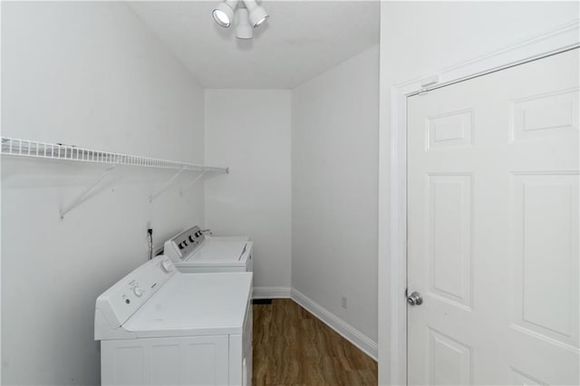 laundry area featuring dark wood-type flooring and independent washer and dryer