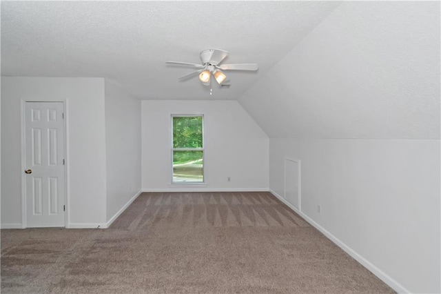 bonus room with lofted ceiling, light carpet, a textured ceiling, and ceiling fan