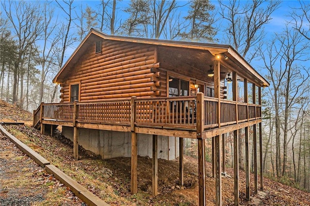 view of home's exterior with a wooden deck and ceiling fan