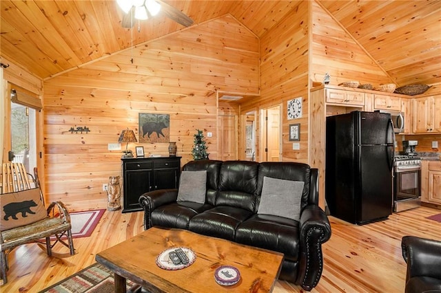 living room with vaulted ceiling and wooden walls