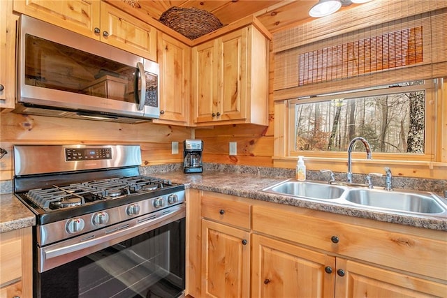 kitchen featuring stainless steel appliances, sink, and light brown cabinetry