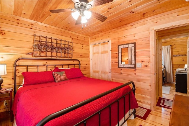 bedroom featuring wooden ceiling, light hardwood / wood-style floors, and wood walls