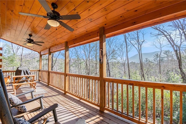 deck with ceiling fan and a mountain view