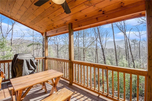 wooden deck featuring ceiling fan