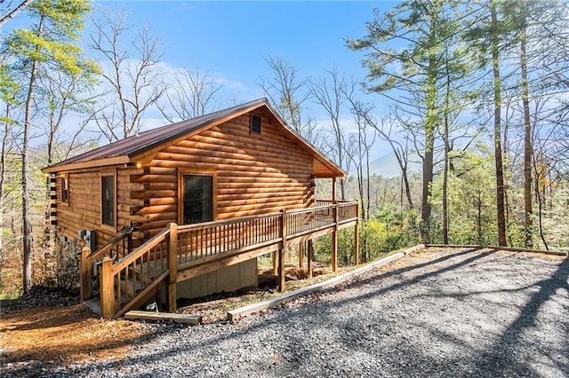 view of side of home featuring a wooden deck