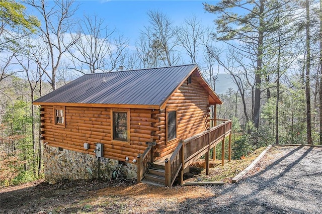 view of side of home with a wooden deck