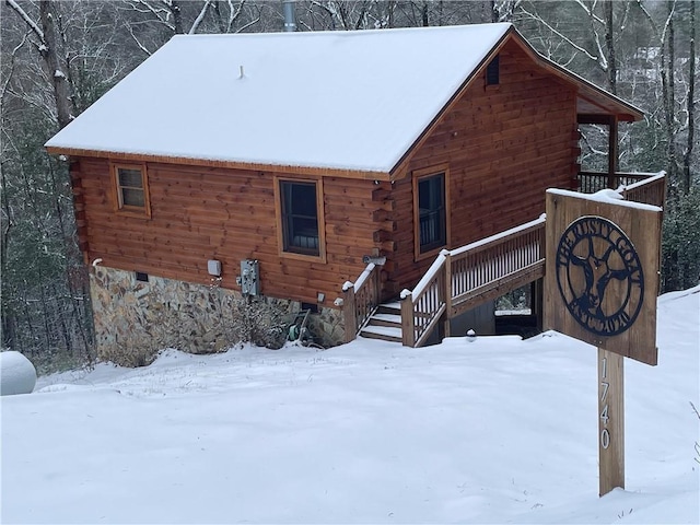 view of snow covered back of property