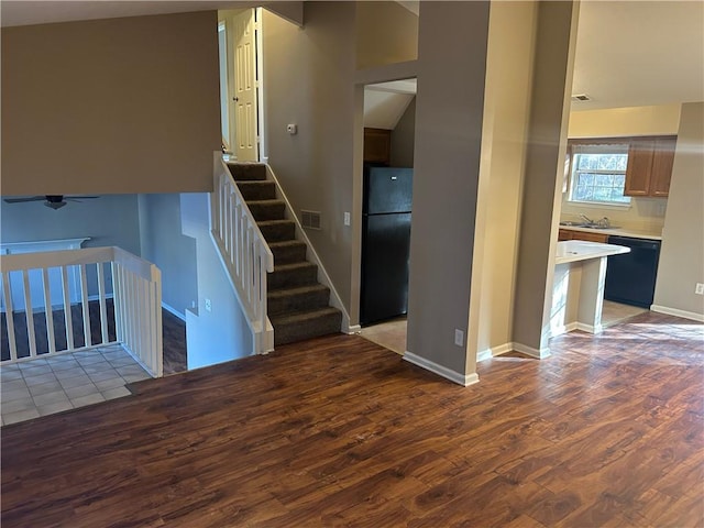 staircase with hardwood / wood-style flooring