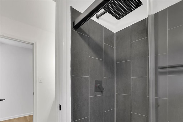 bathroom featuring a shower with shower door and hardwood / wood-style floors