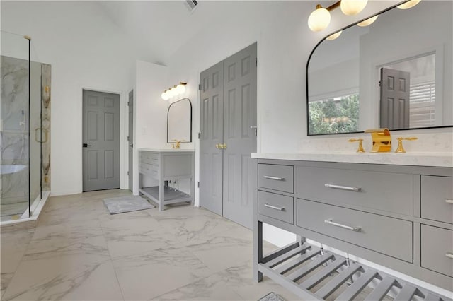 bathroom with vaulted ceiling, walk in shower, and vanity