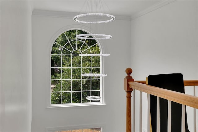 details featuring an inviting chandelier and crown molding