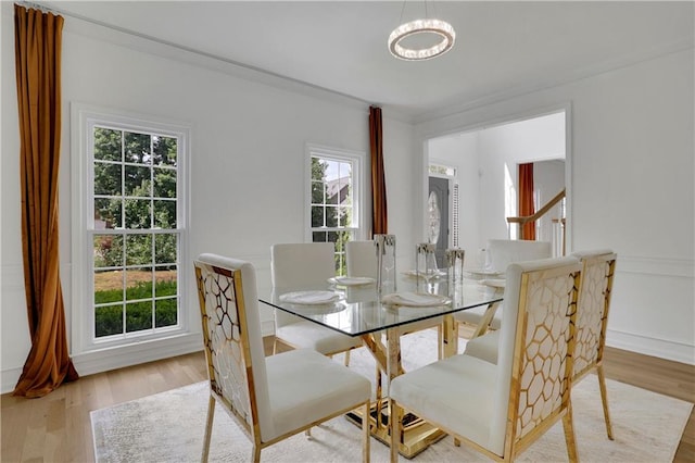 dining area with light hardwood / wood-style flooring and a wealth of natural light