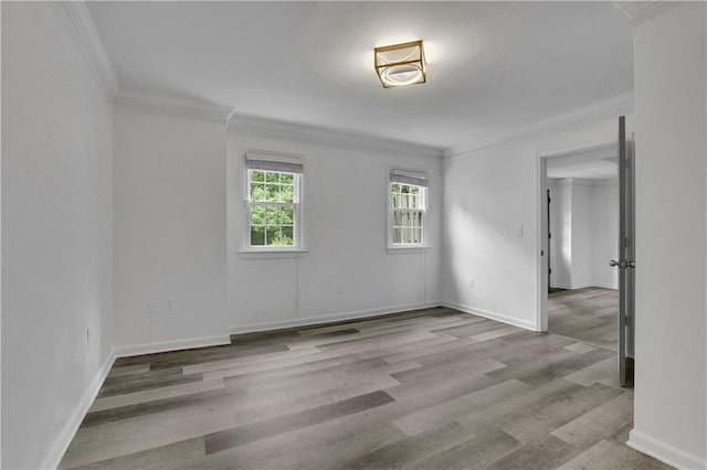 empty room featuring hardwood / wood-style flooring and ornamental molding