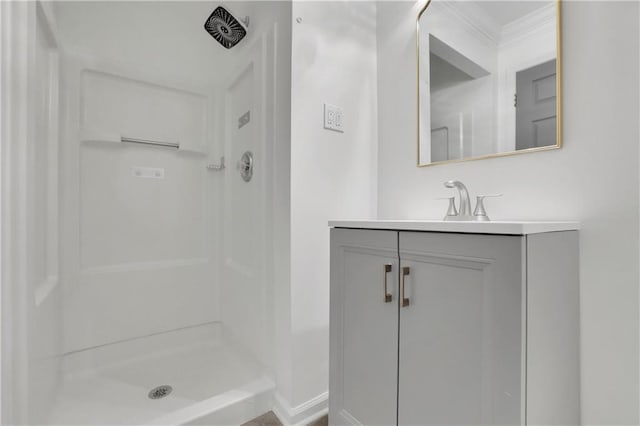 bathroom featuring a shower and vanity