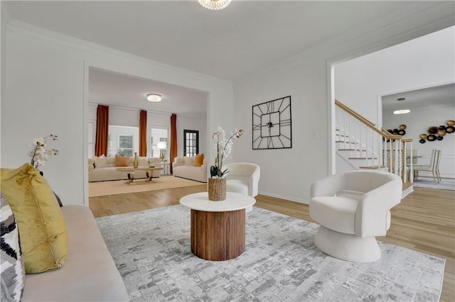 living room featuring crown molding and hardwood / wood-style flooring