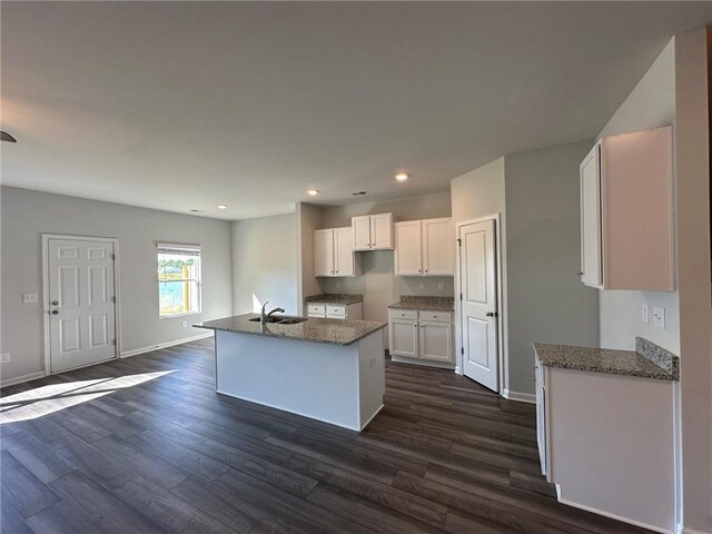 unfurnished living room featuring ceiling fan, stairway, and dark wood-style floors