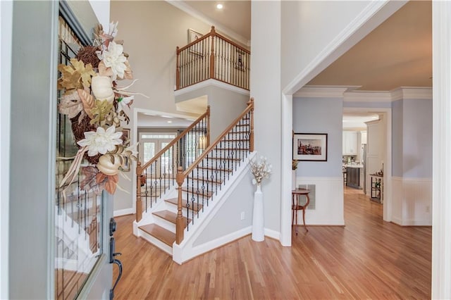 living room featuring light hardwood / wood-style flooring and crown molding